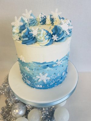 Christmas ombre buttercream cake in blue and white with snowflake decorations