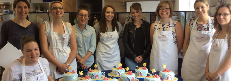 Students at a Catherine Scott cake decorating class with their finished seaside cakes